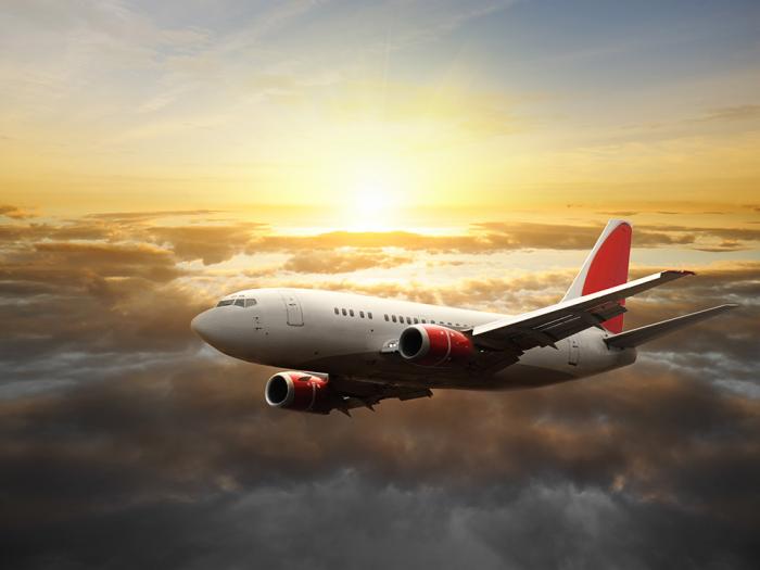 Fototapete Flugzeug über den Wolken