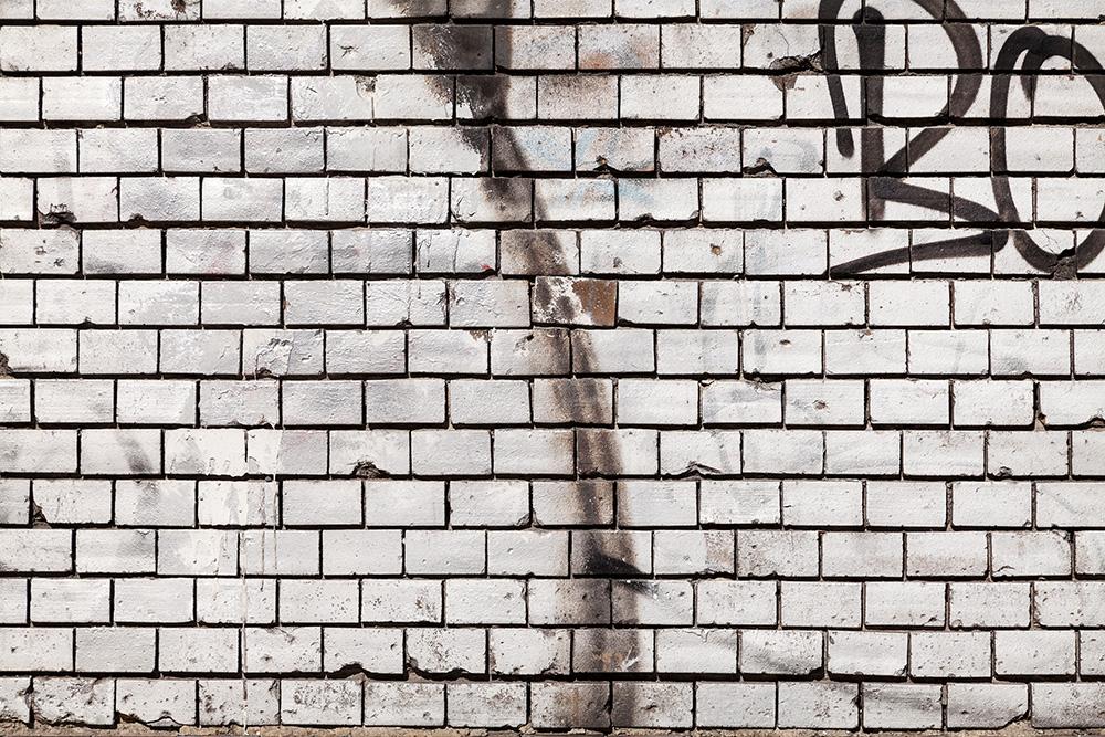 Fototapete Steinmauer mit Graffiti