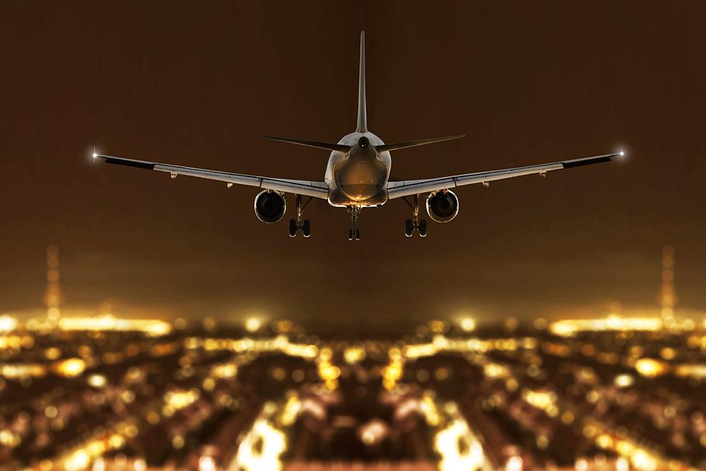 Fototapete Flugzeug bei der Landung bei Nacht