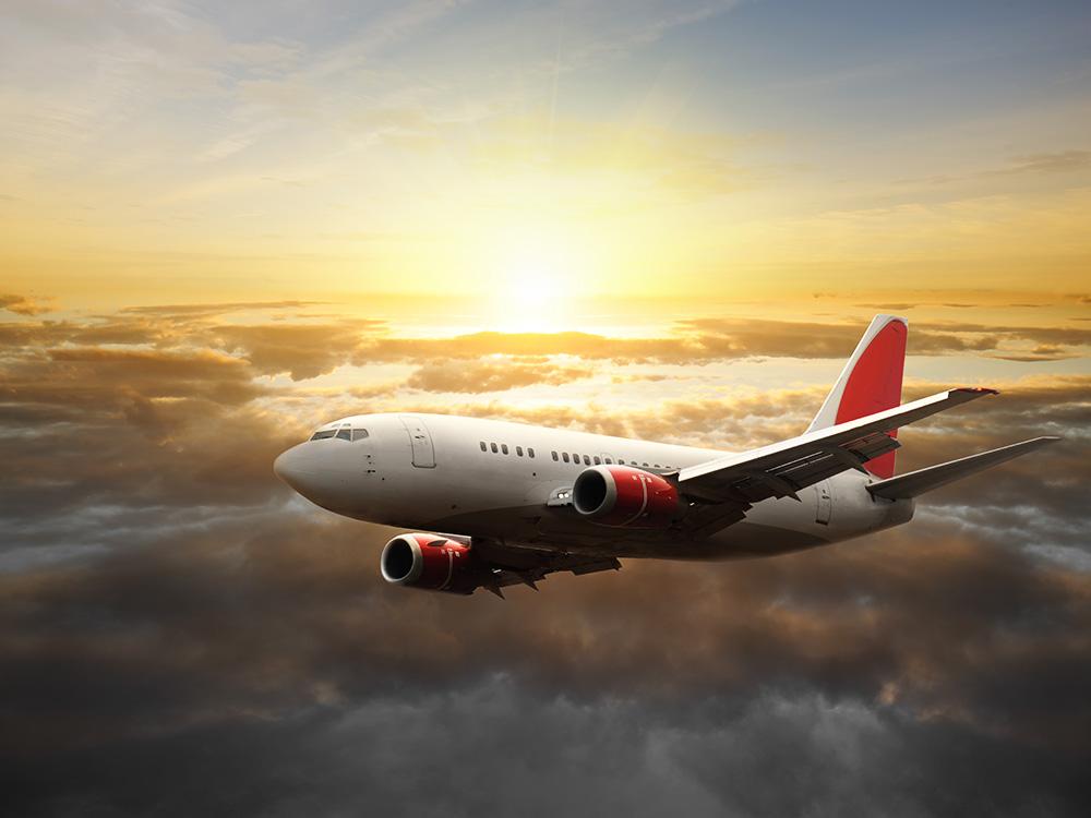 Fototapete Flugzeug über den Wolken