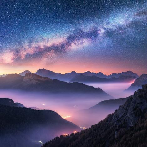 Fototapete Sternenhimmel bei Nacht über nebeligen Bergen